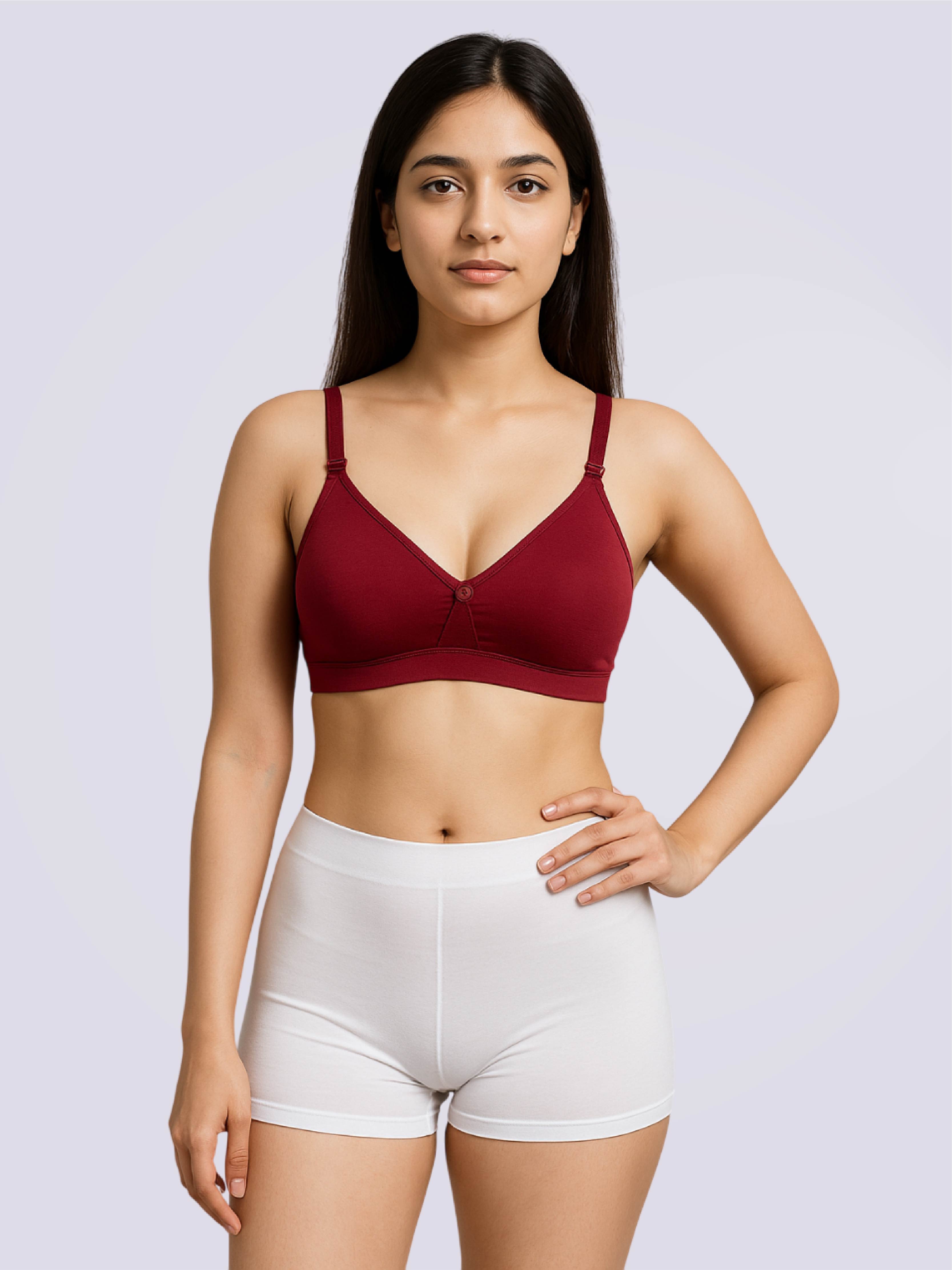 Woman wearing a red bra and white shorts on a light gray background